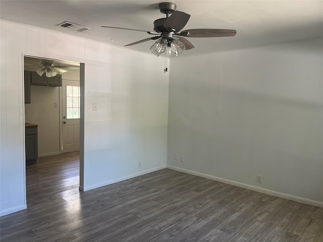 spare room with ornamental molding, dark hardwood / wood-style flooring, and ceiling fan