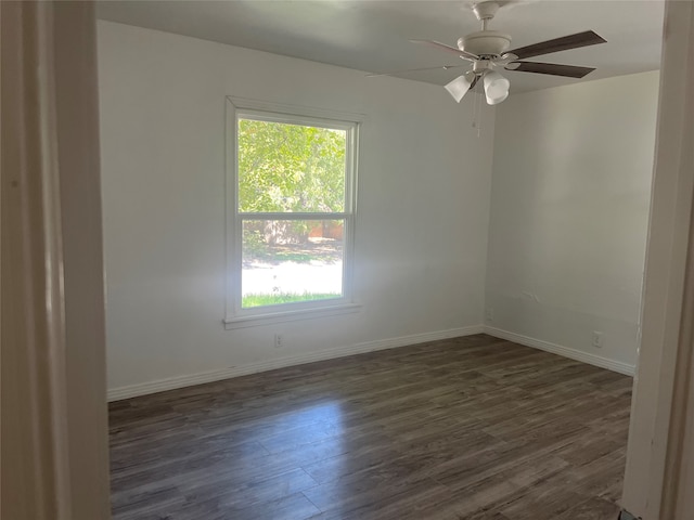 unfurnished room with ceiling fan and dark wood-type flooring