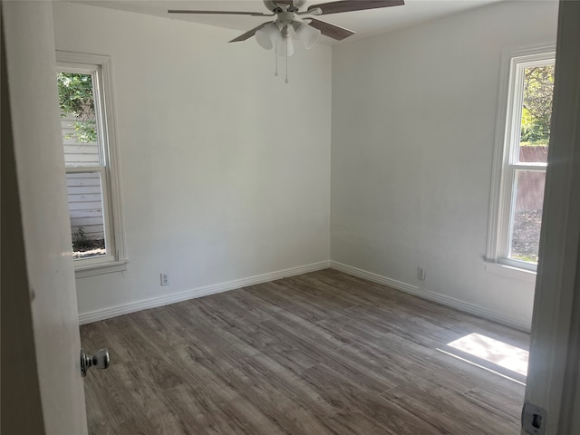 unfurnished room with hardwood / wood-style flooring, ceiling fan, and plenty of natural light