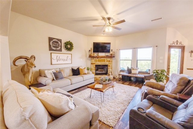 living room featuring a fireplace, plenty of natural light, and hardwood / wood-style floors