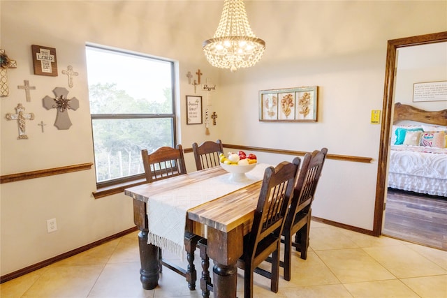 dining room featuring a notable chandelier and light tile patterned flooring