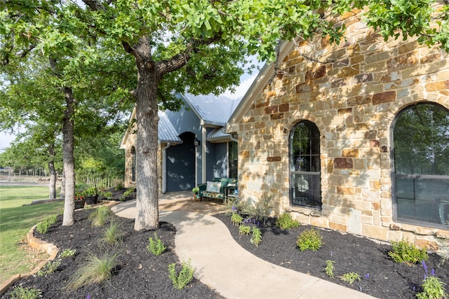 view of exterior entry featuring a patio