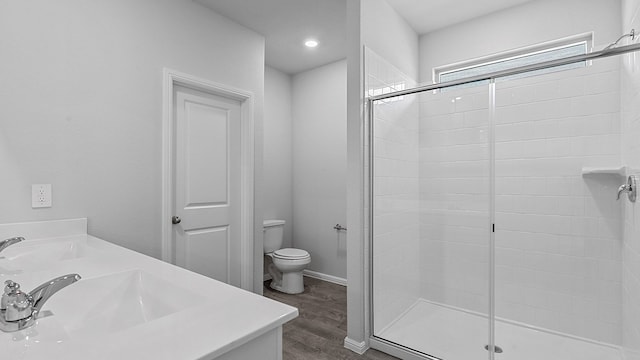 bathroom featuring an enclosed shower, toilet, hardwood / wood-style floors, and double vanity