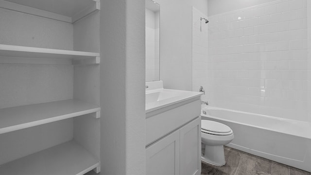 full bathroom featuring hardwood / wood-style flooring, toilet, shower / tub combination, and vanity