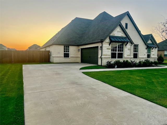 view of front facade with a yard and a garage