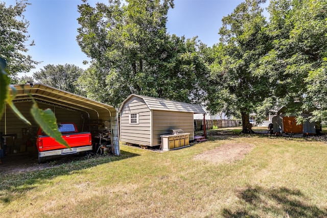 view of yard with a storage shed and a carport