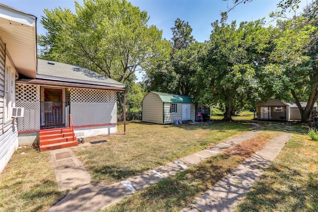 view of yard with covered porch, an outdoor structure, and a storage unit