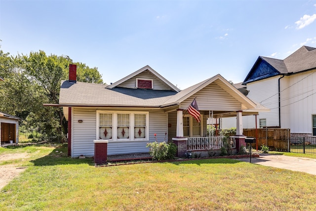 back of house featuring a yard and a porch