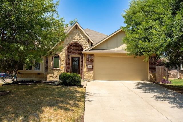 view of front of house with a garage and a front yard