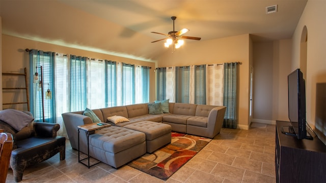 living room with ceiling fan, vaulted ceiling, and light tile patterned floors