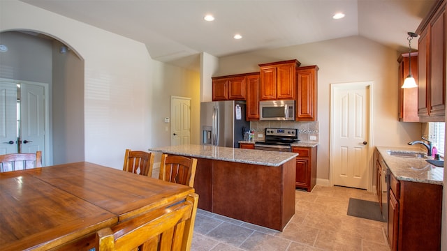 kitchen featuring decorative backsplash, vaulted ceiling, sink, light tile patterned flooring, and stainless steel appliances