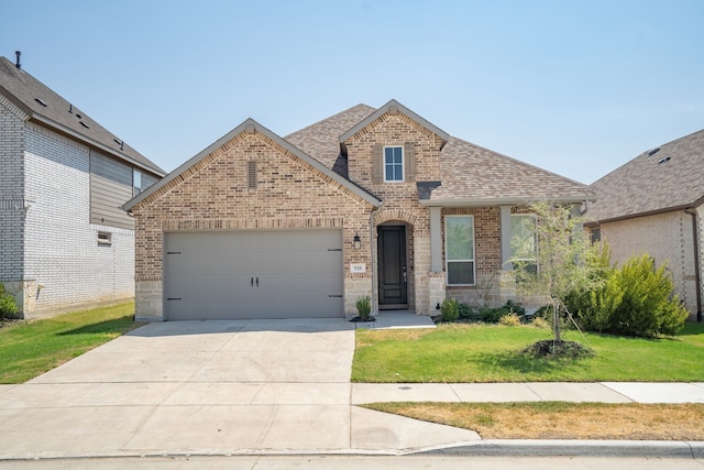 view of front of house with a garage and a front yard