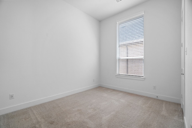 unfurnished room with light carpet