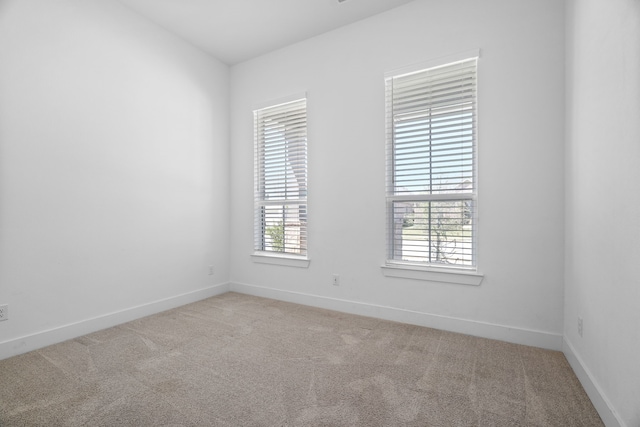 empty room featuring light colored carpet