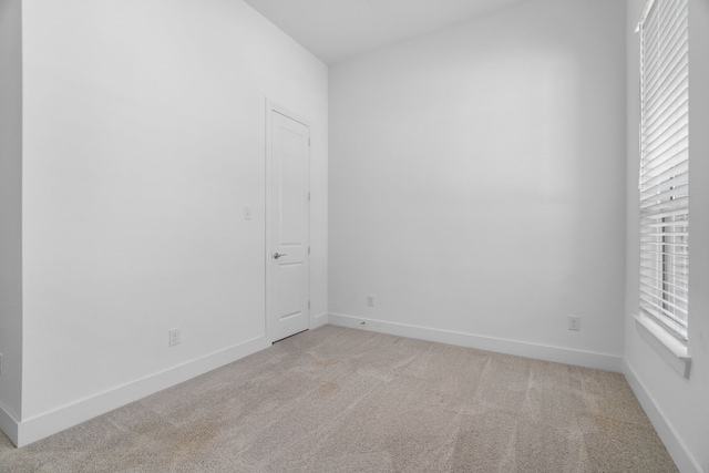 unfurnished room with light colored carpet