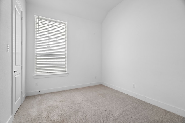 unfurnished bedroom with light carpet and lofted ceiling