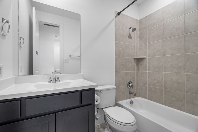 full bathroom with toilet, tiled shower / bath combo, and vanity