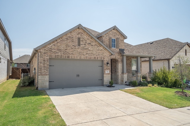 view of front of house with a front yard and a garage