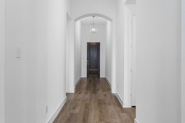 hall featuring hardwood / wood-style floors and a towering ceiling