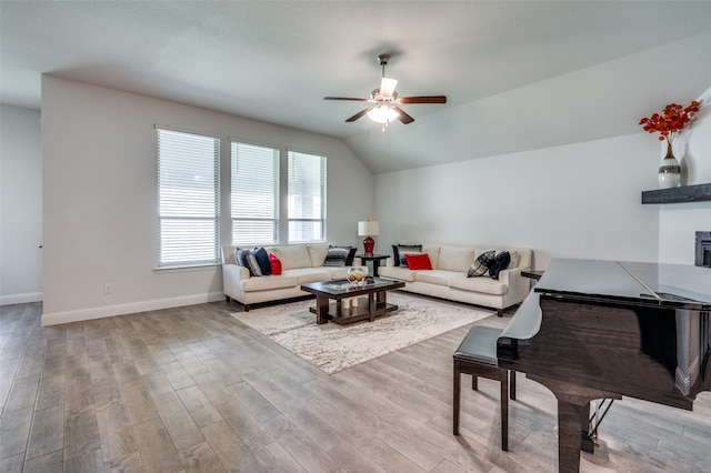 living room with vaulted ceiling, light hardwood / wood-style flooring, and ceiling fan