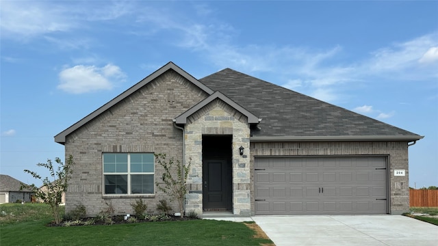 view of front of house with a front yard and a garage