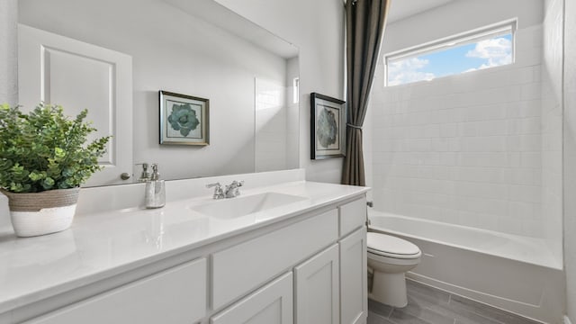 full bathroom featuring shower / bath combination with curtain, vanity, and toilet