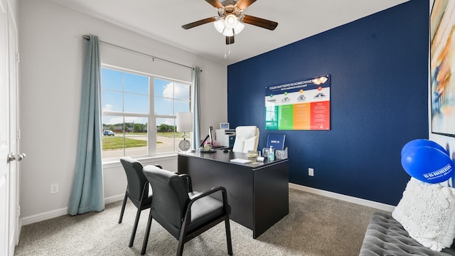 carpeted office space featuring ceiling fan