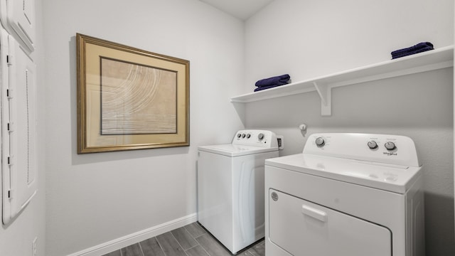 clothes washing area featuring washer and dryer and wood-type flooring