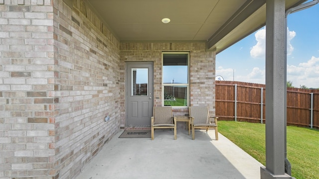 entrance to property with a patio area and a yard