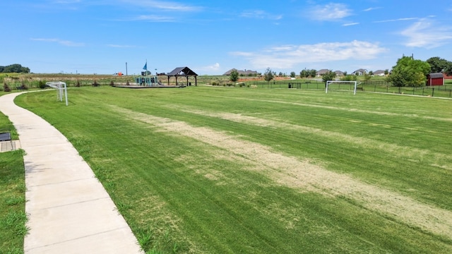 view of home's community featuring a playground and a lawn