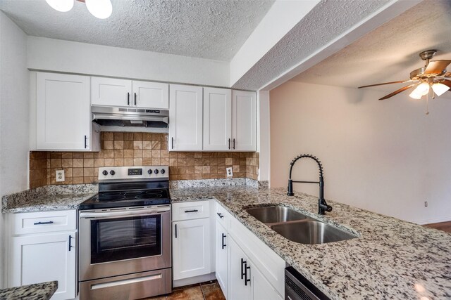 kitchen featuring sink, white cabinetry, decorative backsplash, electric stove, and ceiling fan