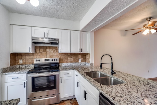 kitchen with under cabinet range hood, a sink, white cabinetry, decorative backsplash, and stainless steel range with electric stovetop