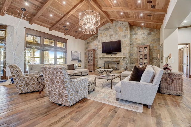 living room featuring high vaulted ceiling, light hardwood / wood-style floors, and wood ceiling