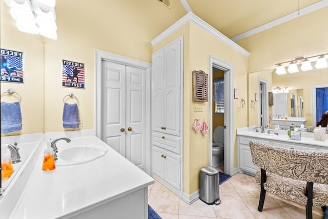 bathroom with tile patterned floors, vanity, toilet, and crown molding