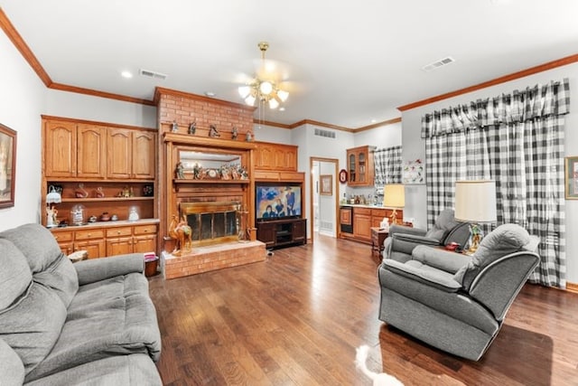 living room featuring ceiling fan, hardwood / wood-style flooring, ornamental molding, and a fireplace