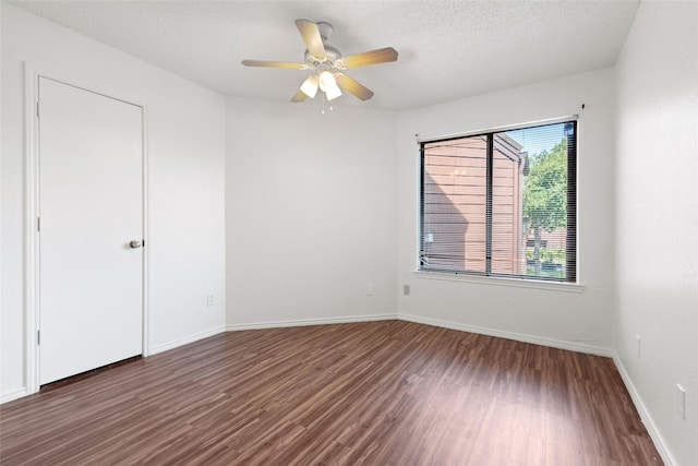 spare room with ceiling fan, dark hardwood / wood-style flooring, and a textured ceiling