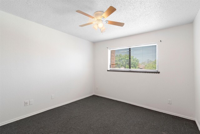 carpeted spare room with ceiling fan and a textured ceiling