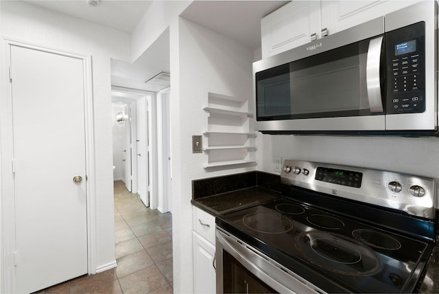 kitchen with white cabinetry, appliances with stainless steel finishes, and tile patterned flooring