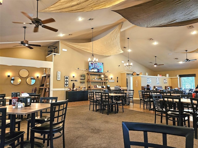 carpeted dining room with an inviting chandelier and high vaulted ceiling