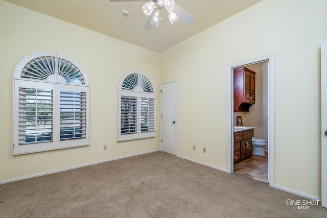 unfurnished room featuring ceiling fan and light colored carpet