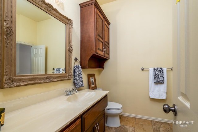 bathroom featuring toilet, tile patterned floors, and vanity