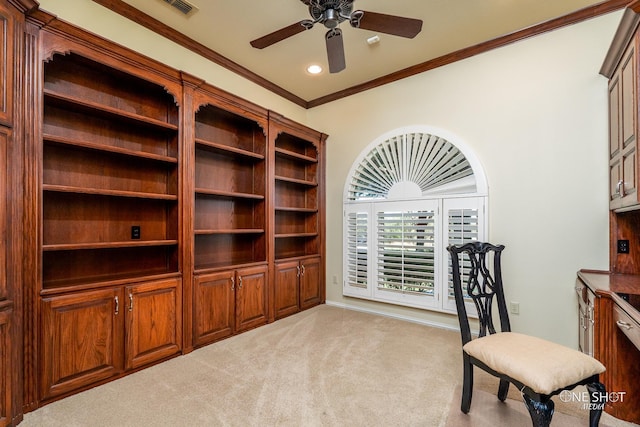 carpeted office space featuring ceiling fan and crown molding