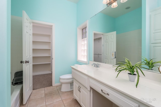 bathroom with toilet, tile patterned floors, and vanity