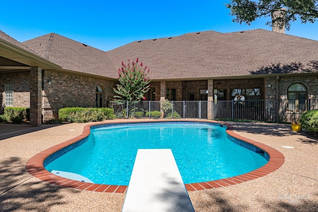 view of pool featuring a diving board