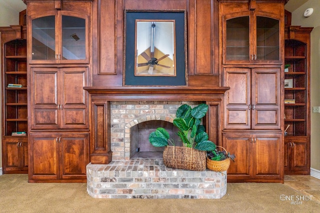 living room featuring light colored carpet and a brick fireplace