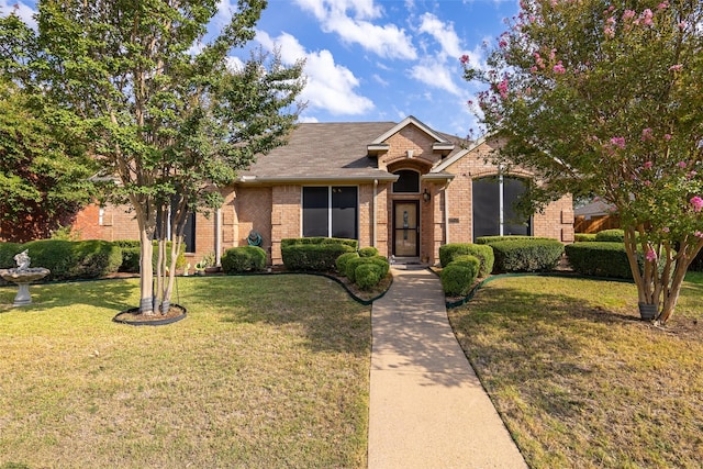 ranch-style home with brick siding and a front yard