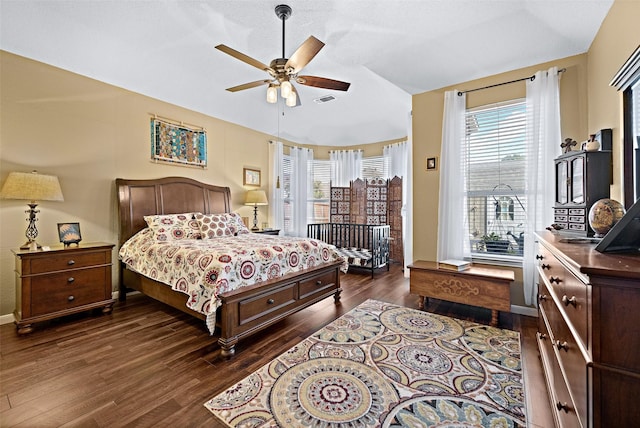 bedroom with dark wood-type flooring, access to outside, visible vents, and ceiling fan