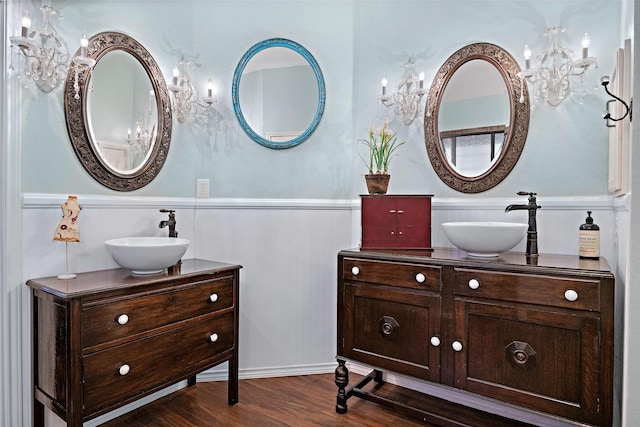 full bathroom featuring a wainscoted wall, wood finished floors, and vanity