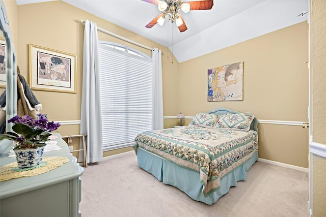 bedroom with lofted ceiling, multiple windows, and light colored carpet