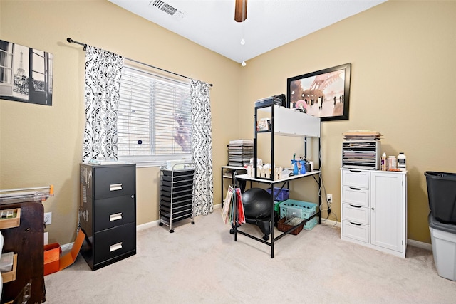 home office featuring light carpet, baseboards, visible vents, and a ceiling fan